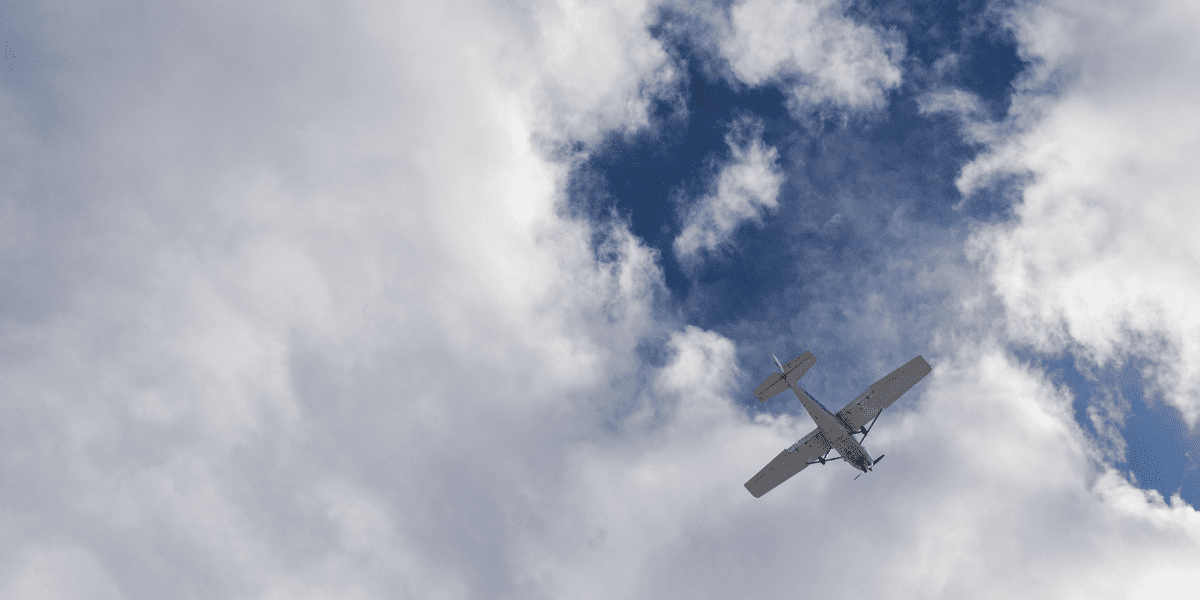 A small plane overhead against a blue sky coming into the Truckee Airport near the Martis Dam Road.
