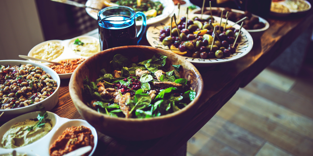 A large meal laid out on a table in a mountain home.