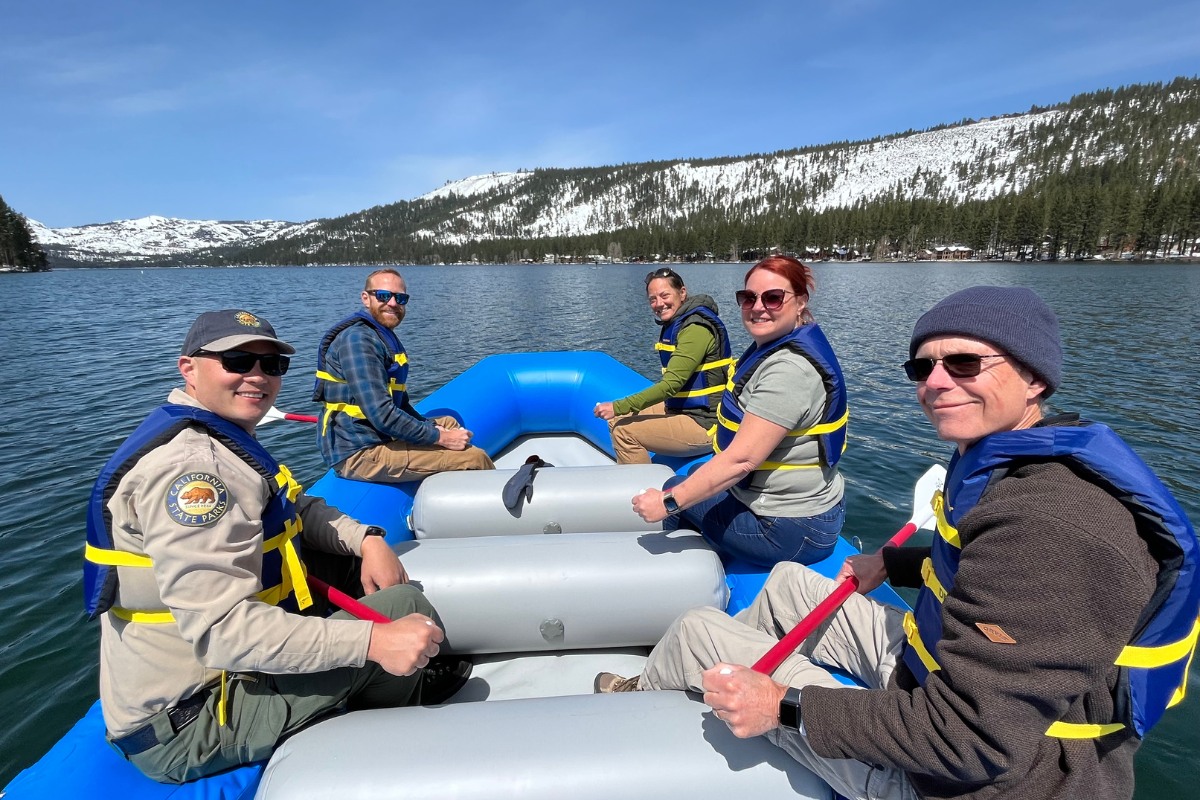 People on blue raft at a Donner Memorial State Park guided paddle tour.