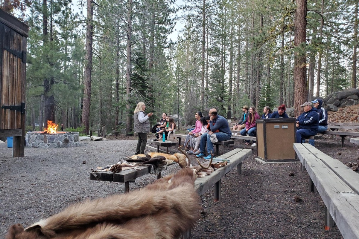 Person leading a Donner Memorial State Park evening program at an outdoor amphitheater.
