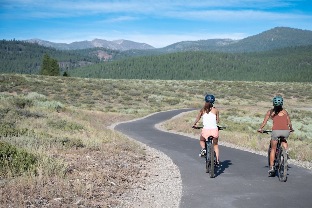Two women riding mountain bikes on the Martis Valley Trail.