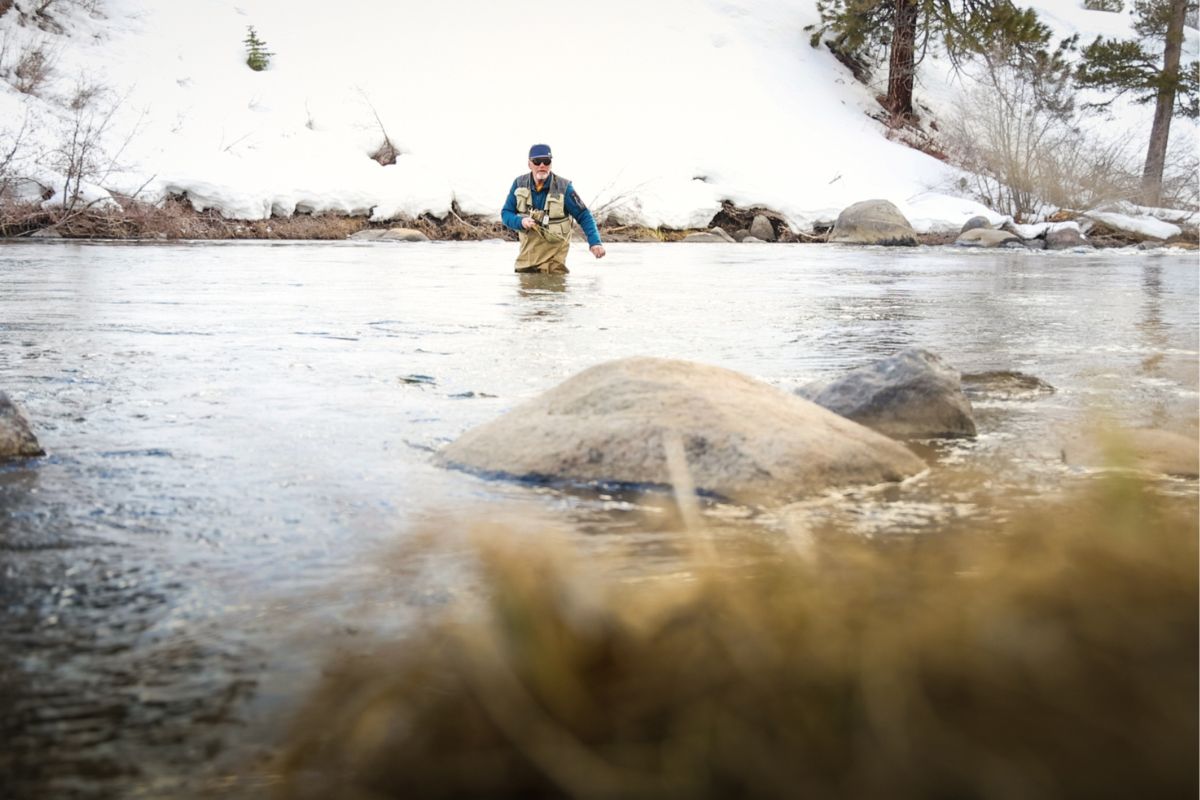 Man fly fishing in the Truckee river in winter.