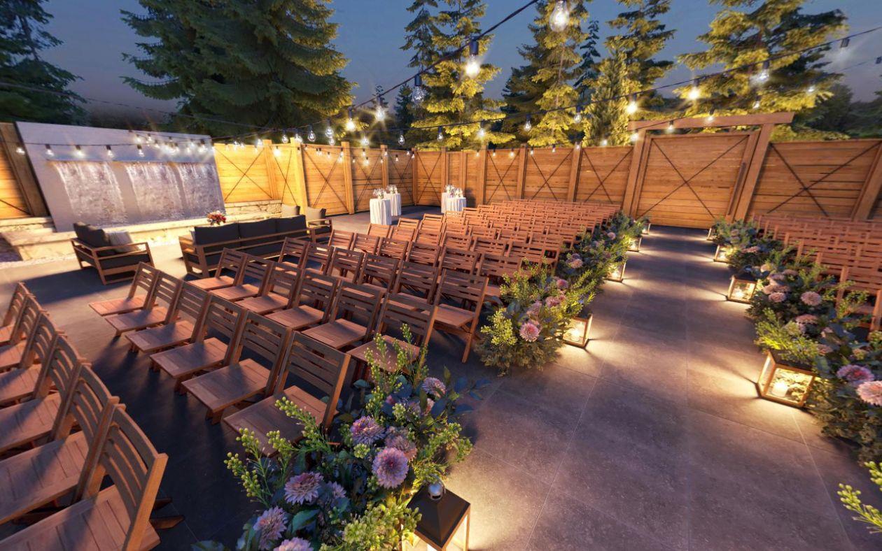 Outdoor wedding venue with string lights, wooden seats, and floral arrangements at dusk.