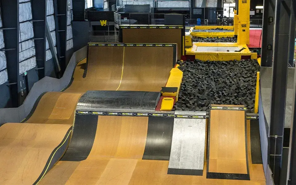 Woodward Indoor skatepark with ramps and a foam pit.