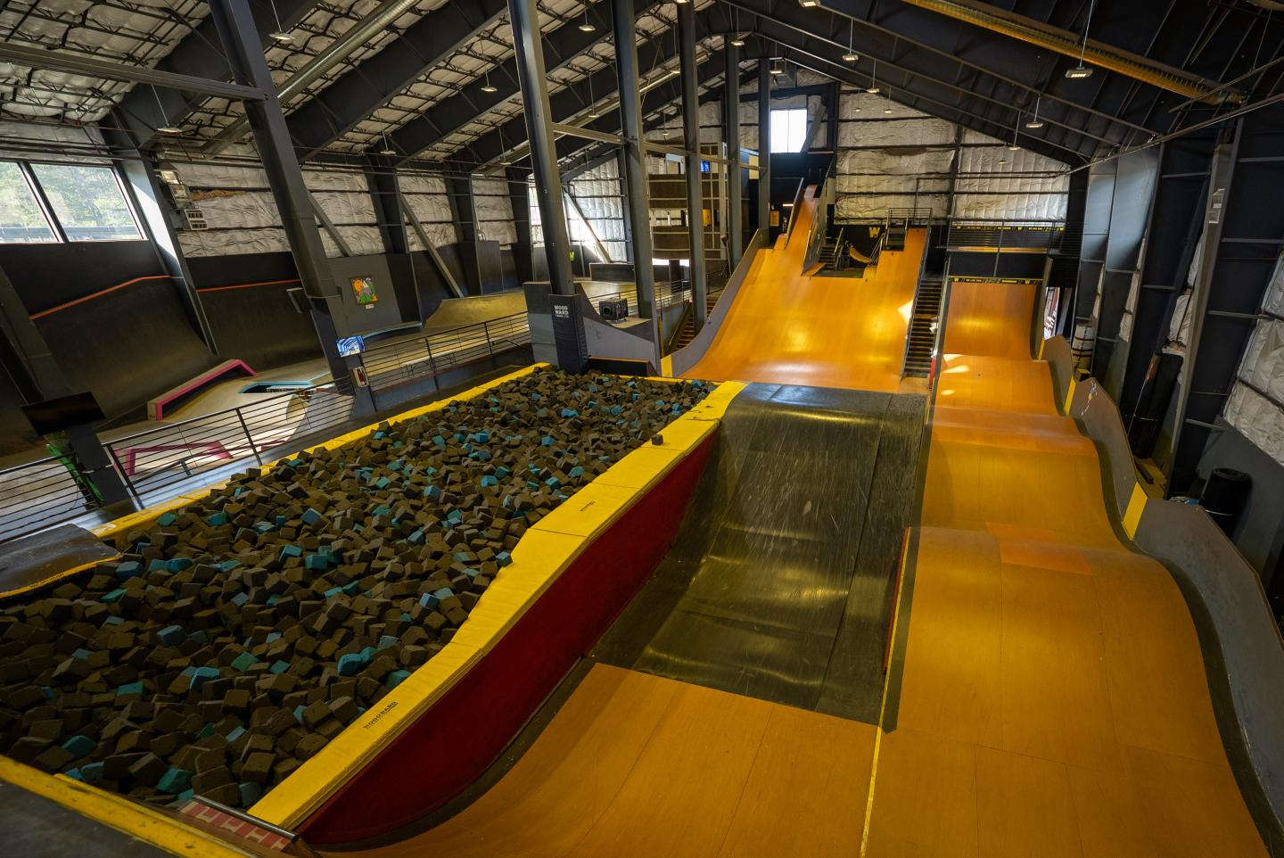 Woodward Indoor skatepark with ramps and foam pit.