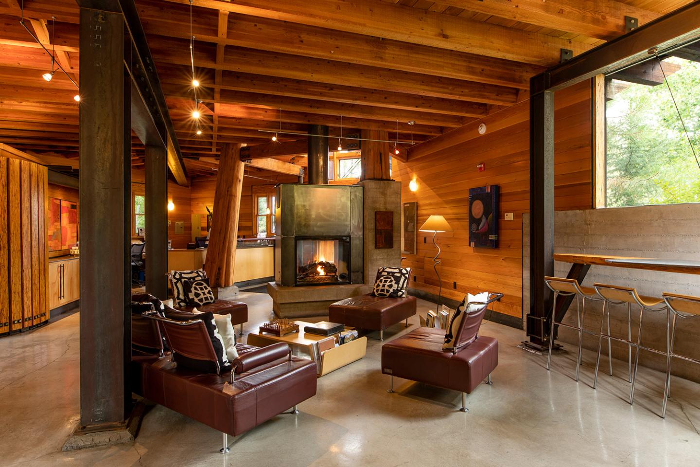 Gravity Haus / Cozy wooden living room with leather sofas and a fireplace.
