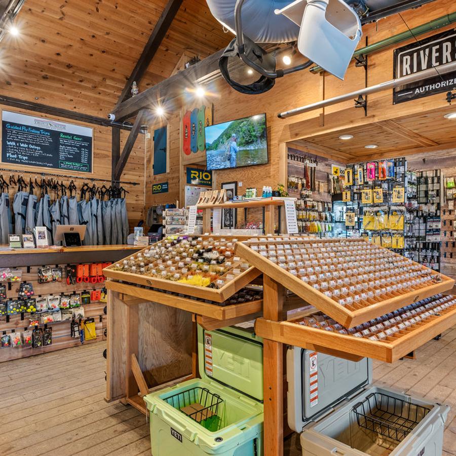 Fishing shop interior with gear, lures, and tackle on display.