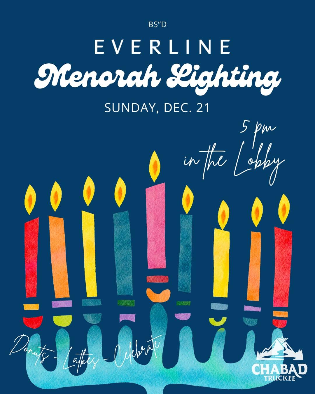 Colorful menorah with nine lit candles on a blue background.