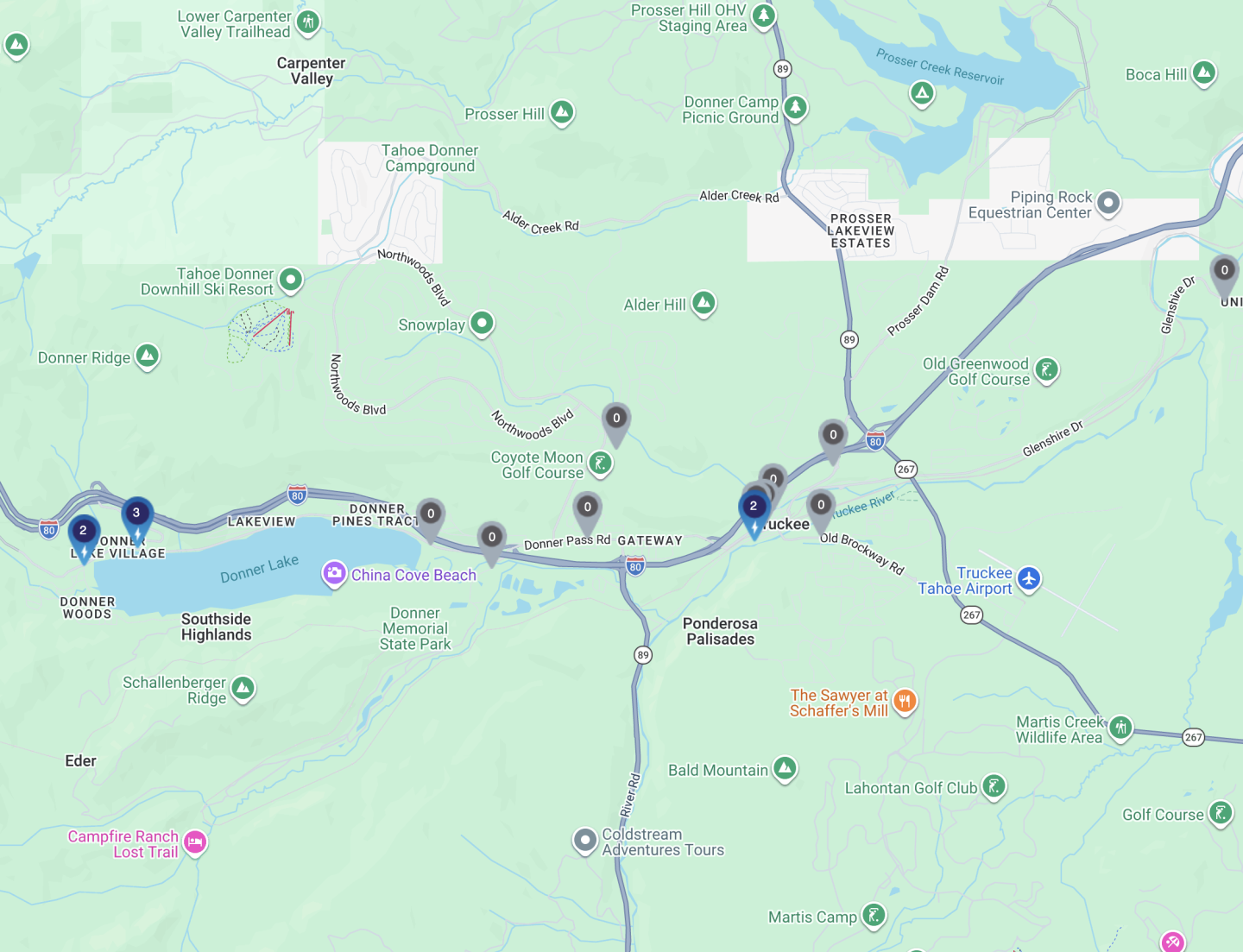 Map showing roads, landmarks, and lakes in a hilly area with various icons.