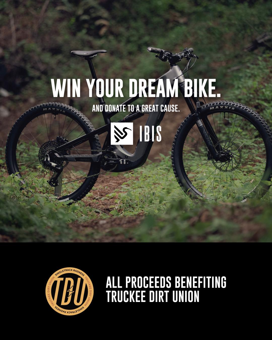 A black bicycle stands on grass with trees in the background. Truckee Dirt Union logo below.