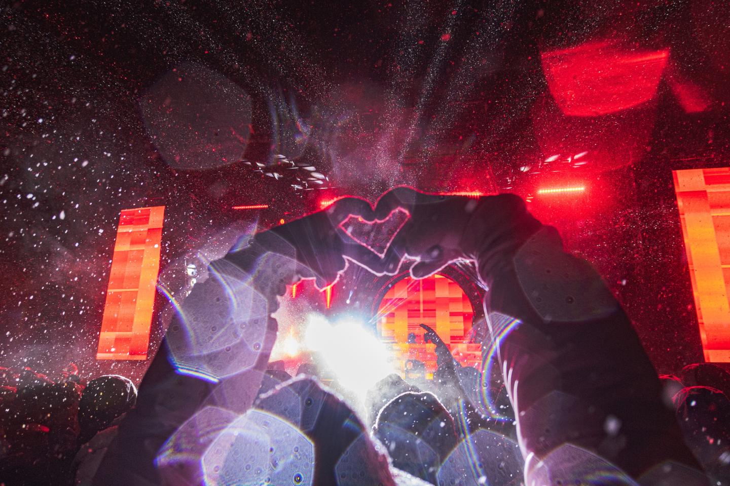 Anime-style robotic figure with glowing red lights amid space debris.